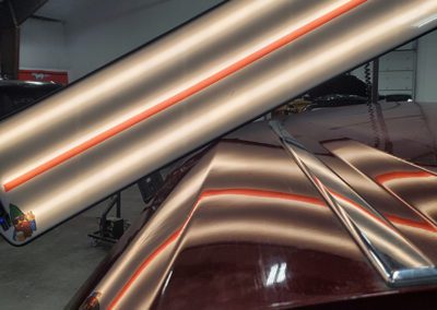 A red car with dent repaired by MBT INC DBA Cheyenne Ding Guy in Cheyenne, WY.